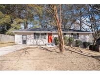 Ranch style home with red front door and driveway at 763 Tara Se Cir, Atlanta, GA 30354