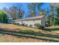 Ranch style home with carport and landscaped yard at 8775 Lee Rd, Lithia Springs, GA 30122