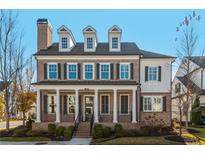 Brick two-story home with dormers, shutters, and a front porch at 765 Belle Isle Dr, Alpharetta, GA 30009