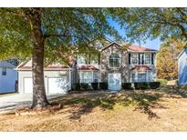 Two story house with stone accents and a red roof at 2459 Wall Se St, Conyers, GA 30013