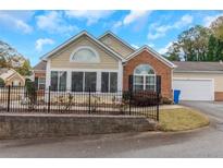 Brick and shingle ranch home with sunroom and fenced-in backyard at 1301 Cascade Park Sw Dr, Atlanta, GA 30331