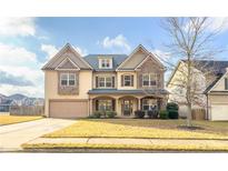 Two-story house with stone accents and a landscaped yard at 5315 Hopewell Manor Dr, Cumming, GA 30028