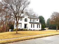 Two-story house with white exterior, black shutters, and a manicured lawn at 1563 Bailey Farms Dr, Lawrenceville, GA 30043