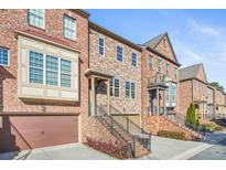 Brick townhouses with attached garages and stairways at 2619 Willow Field Xing, Marietta, GA 30067