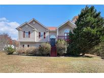 Two-story house with red accents, landscaping, and a staircase leading to the entrance at 3709 Tate Pl, Austell, GA 30106