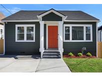Charming craftsman bungalow with gray siding, white trim, and a bright orange door at 541 Sunset Nw Ave, Atlanta, GA 30318