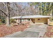 Brick ranch house with attached garage and a large yard at 809 Shadybrook Ne Dr, Marietta, GA 30066