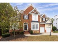 Brick two-story house with a large front yard and attached two-car garage at 2984 Winterthur Close Nw, Kennesaw, GA 30144