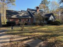 Brick house with large backyard and mature trees at 1200 Lakewood Ne Dr, Conyers, GA 30013