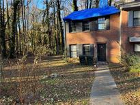 Brick townhouse with a blue tarp covering the roof at 193 Timber Creek Sw Ln, Marietta, GA 30060