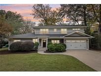 Two-story house with gray siding, solar panels, and a landscaped lawn at 2262 Abby Ne Ln, Atlanta, GA 30345