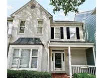 Charming 2-story townhome with white brick exterior and black shutters at 1203 Bridle Path, Marietta, GA 30068