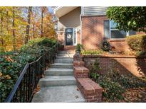 Brick front exterior with steps leading to the entrance, landscaping, and a black metal railing at 71 Dunwoody Springs Dr, Atlanta, GA 30328