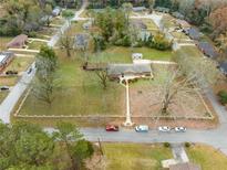 Aerial view showing single-story house with large yard and ample parking at 3645 Aldea Dr, Decatur, GA 30032