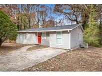 Newly renovated ranch home with gray siding, red door, and a spacious yard at 193 Polar Rock Sw Rd, Atlanta, GA 30315