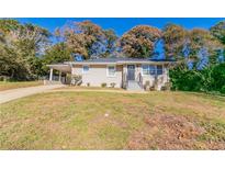 Ranch style home with a brick facade, driveway and landscaping at 4252 Lamar St, Decatur, GA 30035