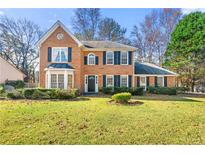 Brick two-story house with a well-maintained lawn and landscaping at 470 Gray Herron Ct, Lawrenceville, GA 30044