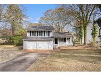 Charming ranch home with a two-car garage and well-manicured lawn at 676 Tarkington S Rd, Stone Mountain, GA 30088