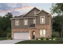 Two-story house with brick and siding exterior, two-car garage, and landscaping at 7065 Brushwood Bnd, Lithonia, GA 30058