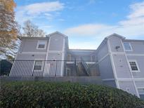 Exterior view of a two-story building with gray siding and a staircase at 4279 Orchard Grv, Stone Mountain, GA 30083