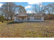 Single-story home with covered front porch and large front yard at 2948 Lenora Rd, Snellville, GA 30039
