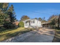 Charming single-Gathering home with a covered front porch, driveway, and fenced backyard at 2631 Godfrey Nw Dr, Atlanta, GA 30318