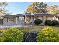 Charming ranch home with gray brick exterior, landscaped lawn, and a welcoming front porch at 1289 Hill Street Se, Atlanta, GA 30315