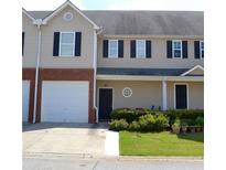 Two-story townhome with a tan exterior, black shutters, and a two-car garage at 45 Eagle Glen Ne Dr, Cartersville, GA 30121