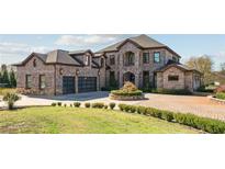 Brick house with three-car garage and circular driveway at 3062 Albion Farm Rd, Duluth, GA 30097