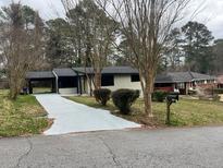 Ranch home with a newly paved driveway and landscaped yard at 2142 Cloverdale Se Dr, Atlanta, GA 30316