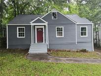 Gray house with red door, steps, and landscaped lawn at 1349 Cleveland Ave, Atlanta, GA 30344