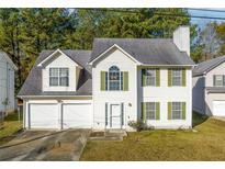 Two-story house with a two-car garage and green shutters at 3559 Six Oaks Ct, Decatur, GA 30034