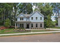 Two-story house with gray siding, landscaping, and a front porch at 4549 Ajo Walk, Atlanta, GA 30331