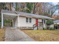 Brick ranch home with covered carport and landscaped yard at 1883 Meadow Ln, Decatur, GA 30032