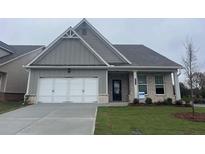 Newly constructed home with gray siding, brick accents, and a two-car garage at 756 Vireo Walk, Loganville, GA 30052