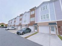 Modern townhouses with attached garages and ample parking at 2005 Ocean Nw Dr, Atlanta, GA 30318