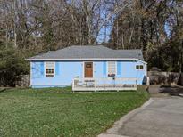 Charming blue house with a white deck and landscaped lawn at 2538 Gordon Se Cir, Smyrna, GA 30080