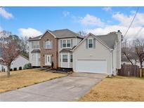 Two-story house with a large yard and attached garage at 4144 Flakes Mill Manor Ln, Ellenwood, GA 30294