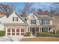 Two-story house with stone accents and a brown-trimmed garage at 3547 Valley Bluff Ln, Snellville, GA 30039