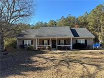 Ranch style home with a covered porch and landscaped yard at 350 Chestnut Dr, Covington, GA 30016