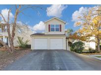 Two-story house with a two-car garage and a well-maintained lawn at 2213 Asquith Sw Ave, Marietta, GA 30008