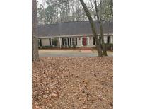 Ranch style home with mature trees and a red front door at 538 Heyward Nw Cir, Marietta, GA 30064