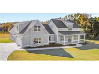 Gray farmhouse exterior with a large front porch and attached garage at 106 Red Oak Ln, Carrollton, GA 30116