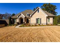 Beautiful brick home with arched entryway and manicured landscaping at 1560 Tapestry Rdg, Lawrenceville, GA 30045