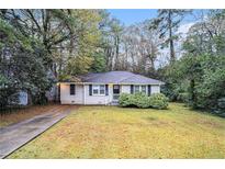 Charming ranch home with a well-manicured lawn and driveway at 2791 Mcafee Rd, Decatur, GA 30032