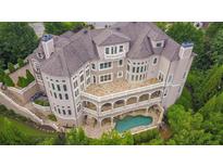 Luxury home with pool and expansive patio, offering stunning views at 1055 Leadenhall St, Alpharetta, GA 30022