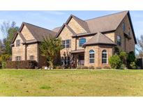 Brick house with a large front yard and mature landscaping at 120 Broad Meadows Ln, Fayetteville, GA 30215