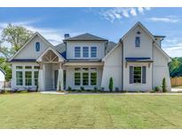 Two-story house with white brick exterior, gray shutters, and a large front yard at 522 Hope Hollow Ln, Loganville, GA 30052