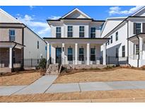 Two-story house with white siding, brick accents, and a front porch at 110 Stonehouse Dr, Cumming, GA 30040