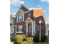 Brick front townhouse with a charming porch and landscaping at 309 Creekbank Se Way, Smyrna, GA 30082